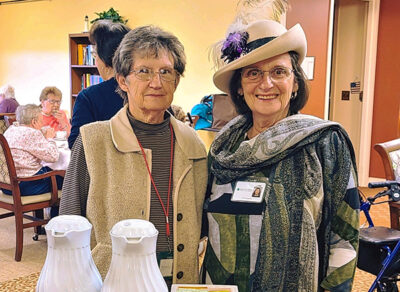 Two ladies standing together smiling
