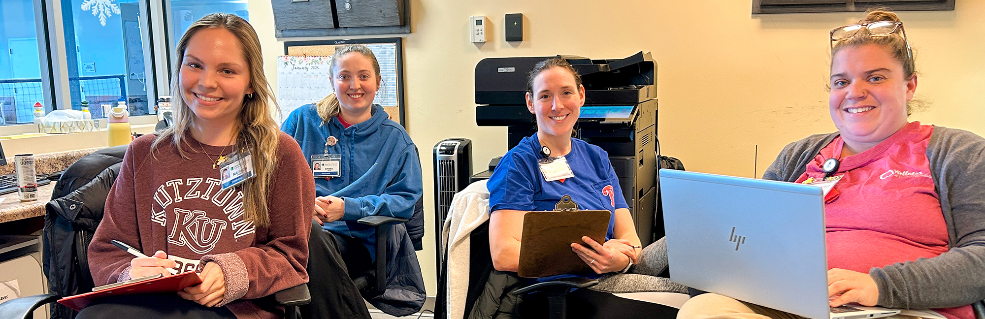 a group of retirement home care workers smiling together