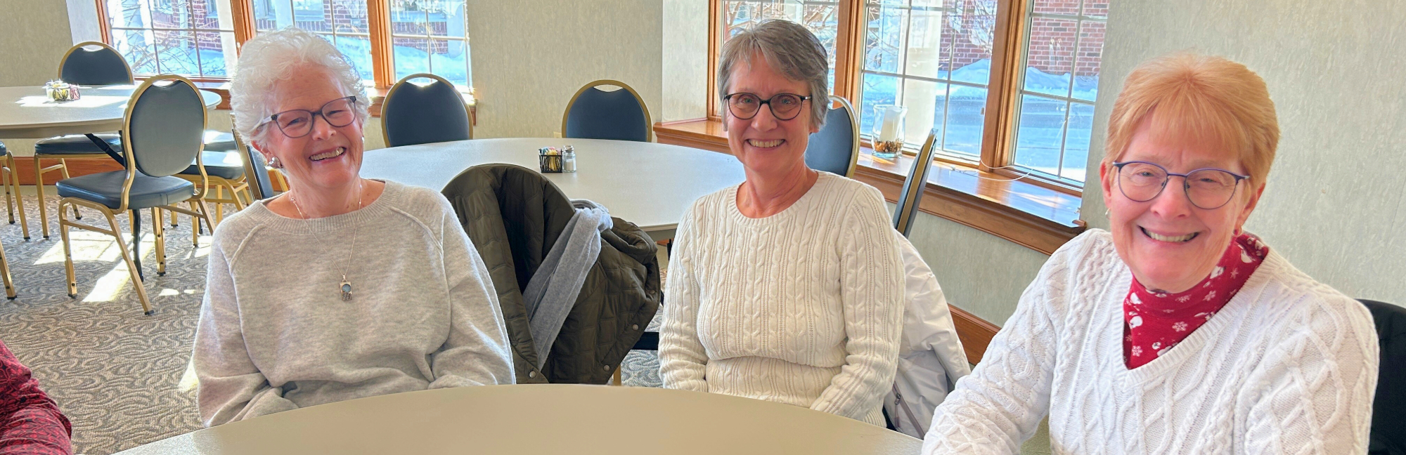 Three older ladies enjoying social time together